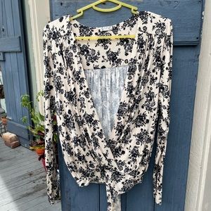 Low cut long sleeved black and white floral free people leotard size medium